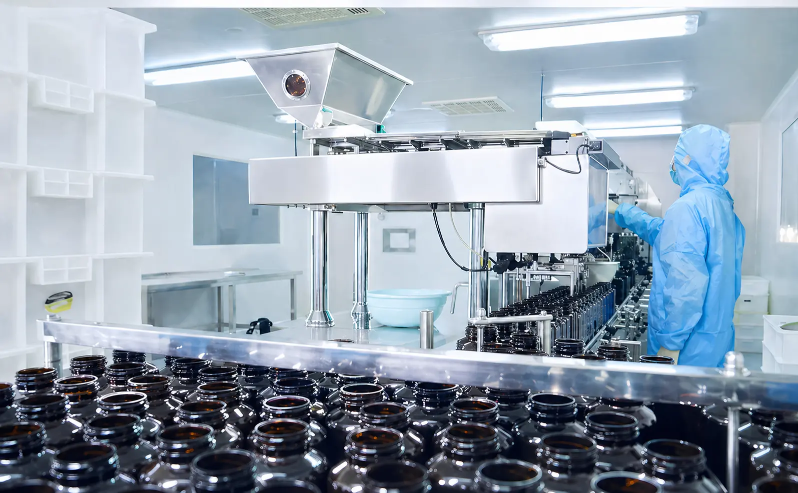 operator working beside a supplement packaging line