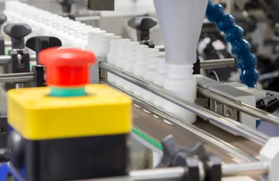 Bottles passing through a supplement bottling line