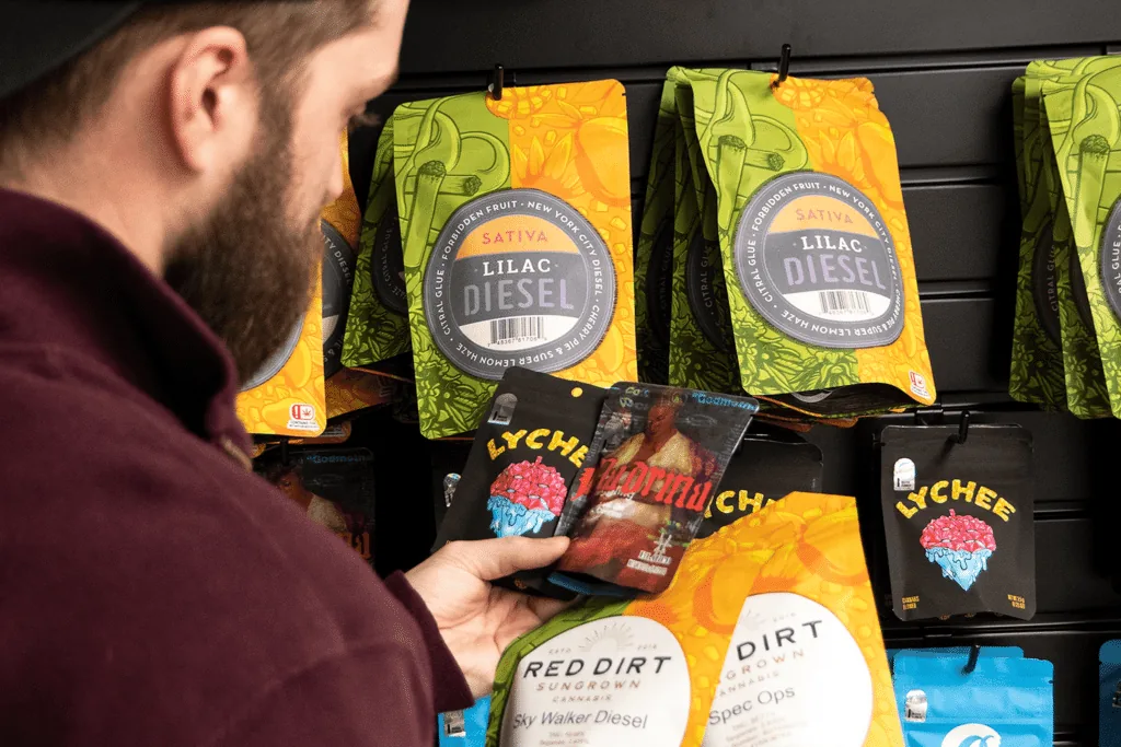 Printed gummy pouches displayed on a retail packaging rack